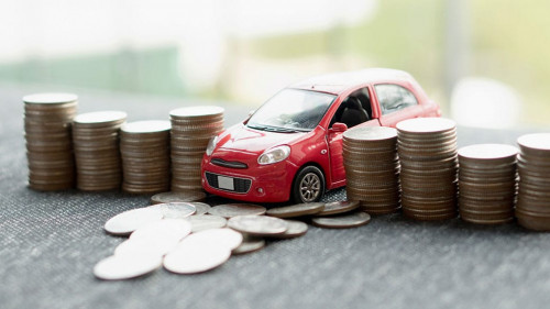 red car over a lot of stacked coins