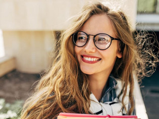 Closeup portrait of a smiling young student woman wearing transp