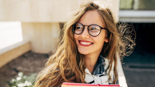 Closeup portrait of a smiling young student woman wearing transp
