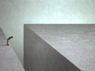 man on the edge afraid of jumping onto the other side