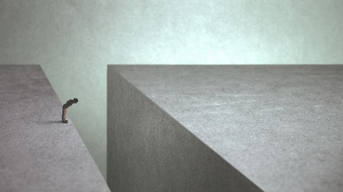 man on the edge afraid of jumping onto the other side