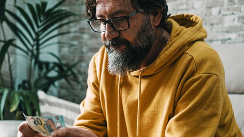 Economy and money people problem concept. Man holding cash bankn