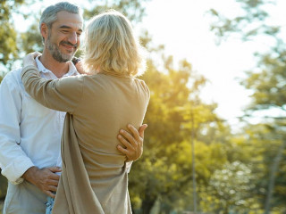 Senior Caucasian couple hugging in park. Family with a happy smi