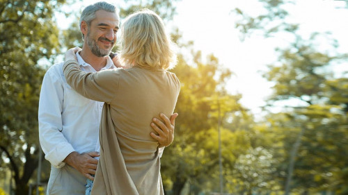 Senior Caucasian couple hugging in park. Family with a happy smi