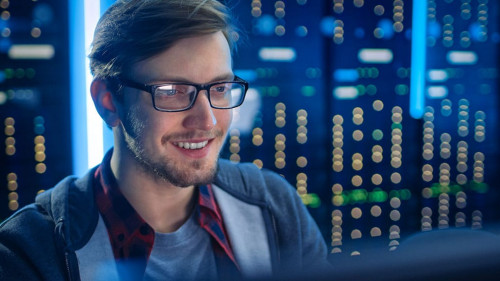 Portrait of Smart SmilingFocused Young Man Wearing Glasses Worki