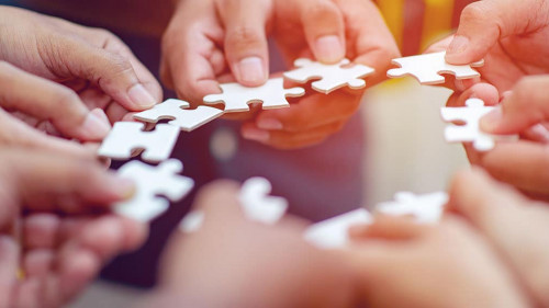 Team work, hands and jig Saw Unite with power Is a good team of