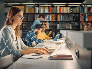 University Library: Talented Caucasian Girl Sitting at the Desk,