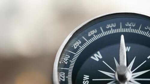 Close-up brass antique compass on marble table
