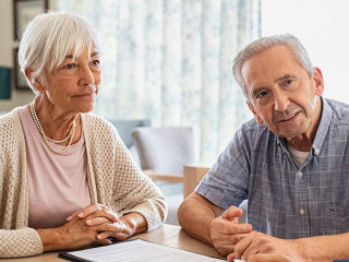 Senior couple planning their investments with financial advisor