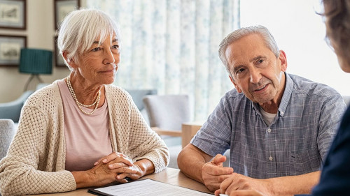 Senior couple planning their investments with financial advisor