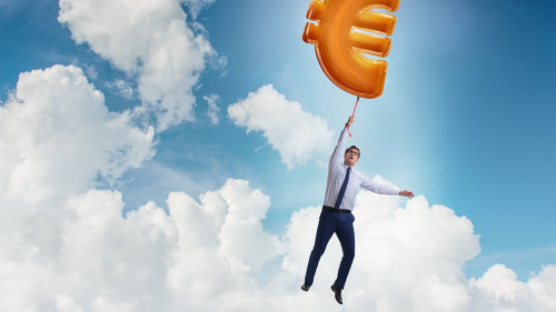 Businessman flying on euro sign inflatable balloon