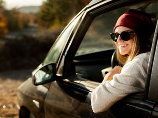 Woman driving in the car on the road trip