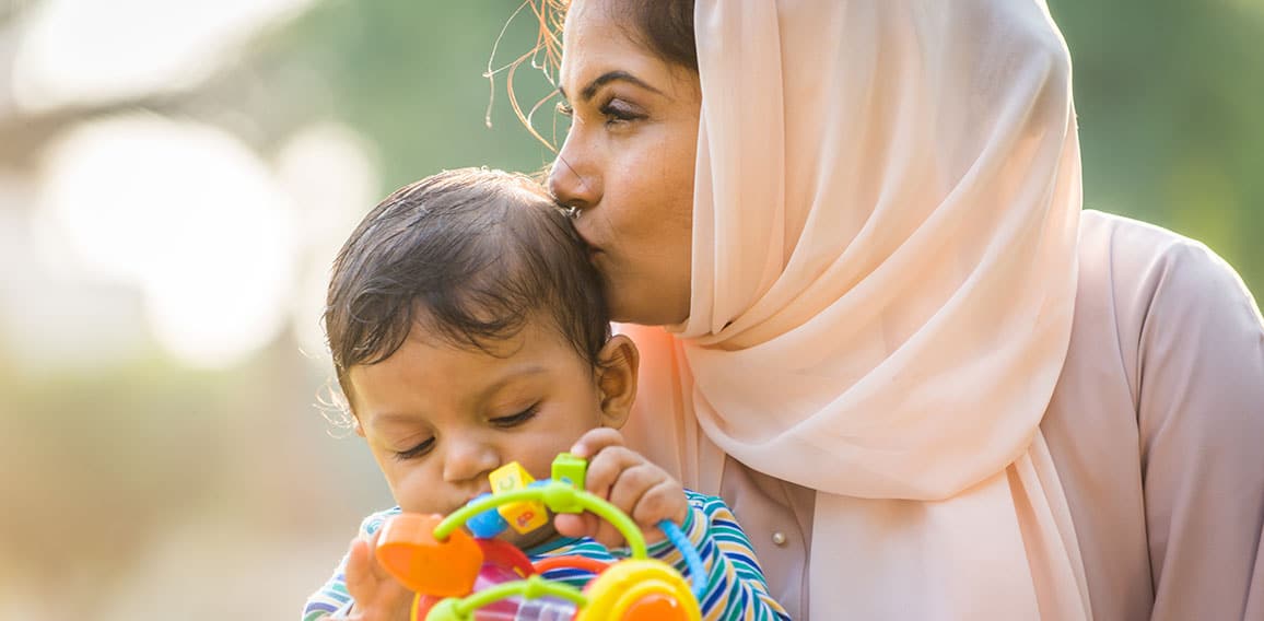 Arabic mom and her little toddler playing outdoors