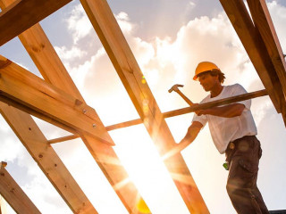 roofer ,carpenter working on roof structure at construction site
