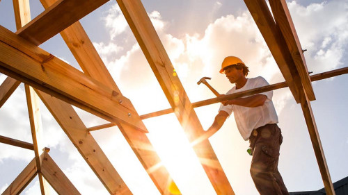 roofer ,carpenter working on roof structure at construction site