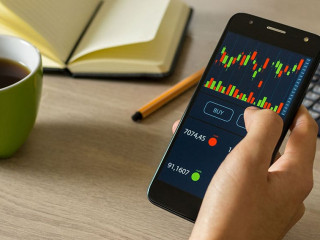 Young man reviewing and investing in the stock market with techn