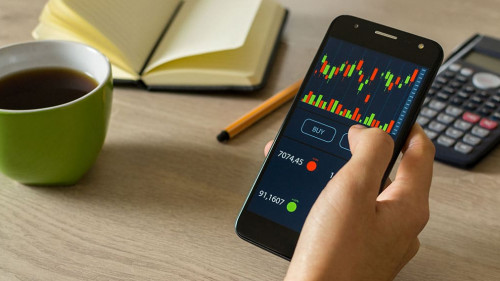 Young man reviewing and investing in the stock market with techn