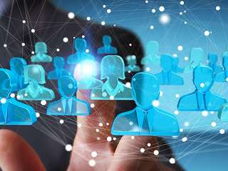 Businessman holding 3D rendering group of blue people