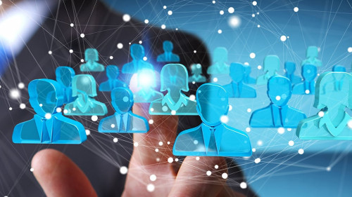 Businessman holding 3D rendering group of blue people