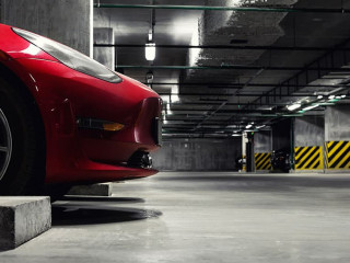 Dark scenic car park underground multilevel garage interior. Concrete cement column covered building basement floor electric vehicle parking lot zone. Modern urban city traffic infrastructure concept