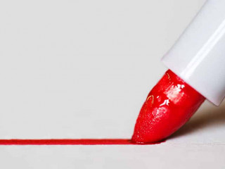 Red marker draws a line close up photo