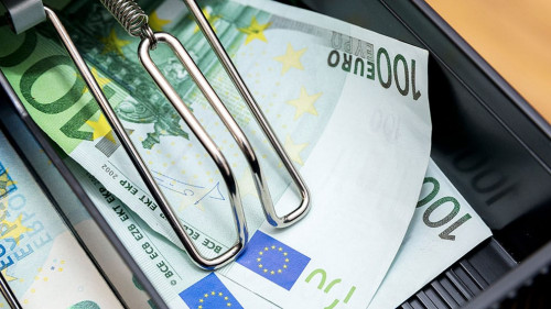 Cash register with coins and paper money