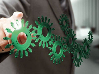 business man hand point cogs icons in board room