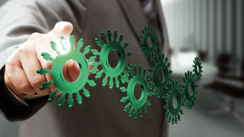 business man hand point cogs icons in board room