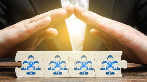 A businessman provides support and insurance for a team of employees. The leader protects the group. Customer and employee care. Patron, community sponsorship and funding.