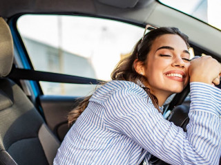 Young Woman Embracing Her New Car. Excited young woman and her n