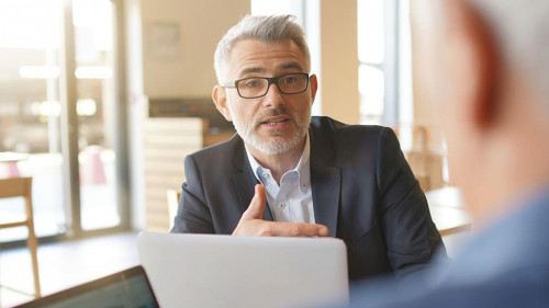 Work colleagues discussing ideas in informal business meeting