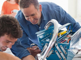 Plumbers working on kitchen sink