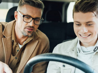 handsome father pointing on something while teaching smiling tee
