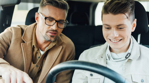 handsome father pointing on something while teaching smiling tee