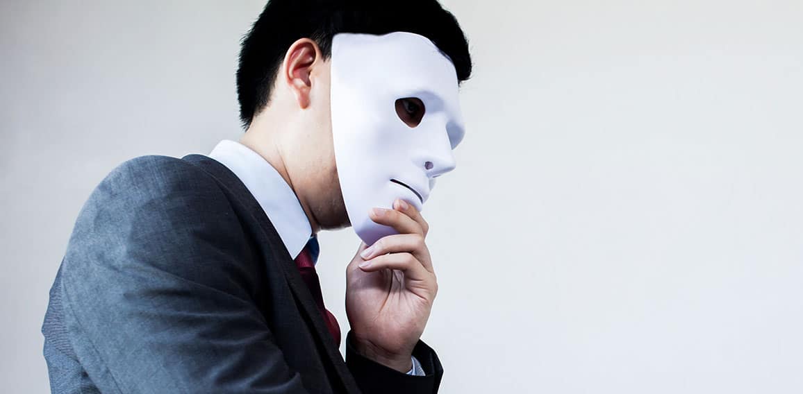 Business man giving dishonest handshake hiding in the mask - Business fraud and hypocrite agreement