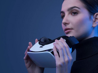 Beautiful woman holding a VR headset