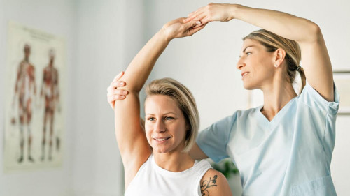 A Modern rehabilitation physiotherapy worker with woman client