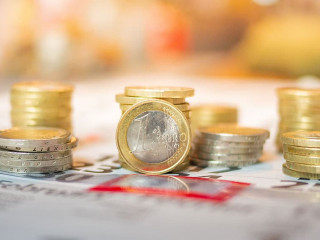 Image of Euro coin stacks on calender indicating pay day