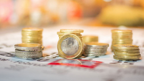 Image of Euro coin stacks on calender indicating pay day