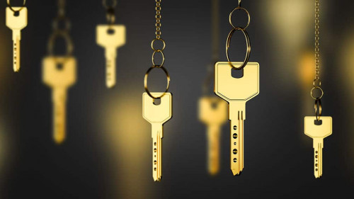 Gold keys on chains, real estate concept