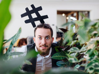 Young businessman standing in office, party concept.