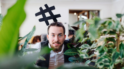 Young businessman standing in office, party concept.
