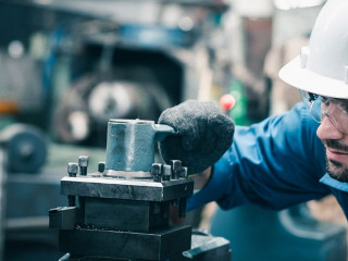 Men industrial engineer wearing a white helmet while standing in