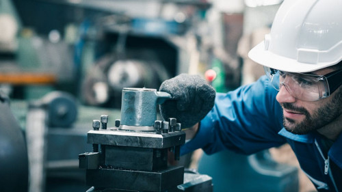 Men industrial engineer wearing a white helmet while standing in