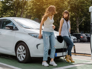 Two happy young beautiful women are talking to each other until