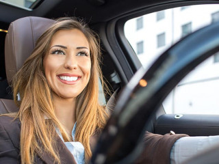 Beautiful businesswoman smiling in a car