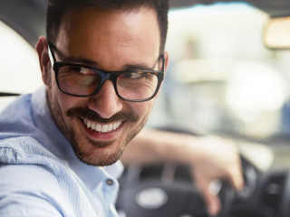 Handsome businessman driving a car to work