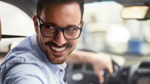 Handsome businessman driving a car to work