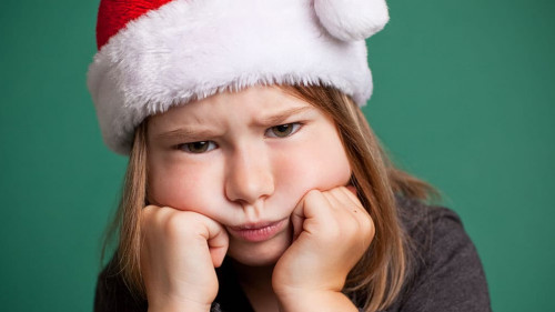 Grumpy Christmas Girl in Santa Hat, Isolated on Green