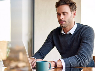 Young businessman working on a laptop at home